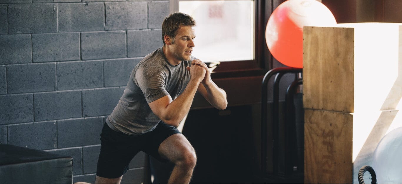 Man doing squats on a training session